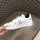 L Trainer Low Top White And Green Graphic Print Leather Sneakers held up showing profile L Trainer Low Top White And Green Graphic Print Leather Sneakers held up showing profile