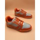 Overhead Angle of L Orange And Grey Low Top Trainer Sneakers Overhead perspective of L orange and grey low top trainer sneakers on display