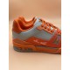 Rear View of L Orange And Grey Low Top Trainer Sneakers Rear quarter view of L orange and grey low top trainer sneakers highlighting heel detail