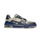 Profile view of L Trainer low top grey and navy blue leather sneakers showing side script logo