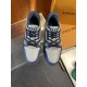 Top down view of L Trainer grey and navy blue leather sneakers displaying laced tongue and branding