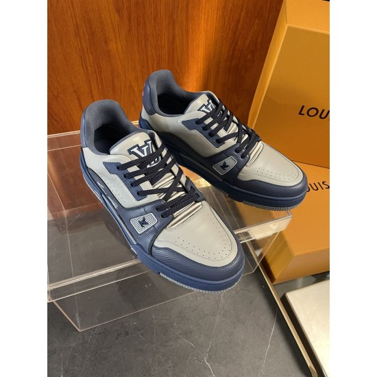 Angled pair view of L Trainer grey and navy blue leather sneakers on display surface