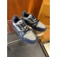 Angled pair view of L Trainer grey and navy blue leather sneakers on display surface