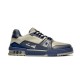 Studio profile view of L Trainer low top grey and navy blue leather sneakers against a plain background
