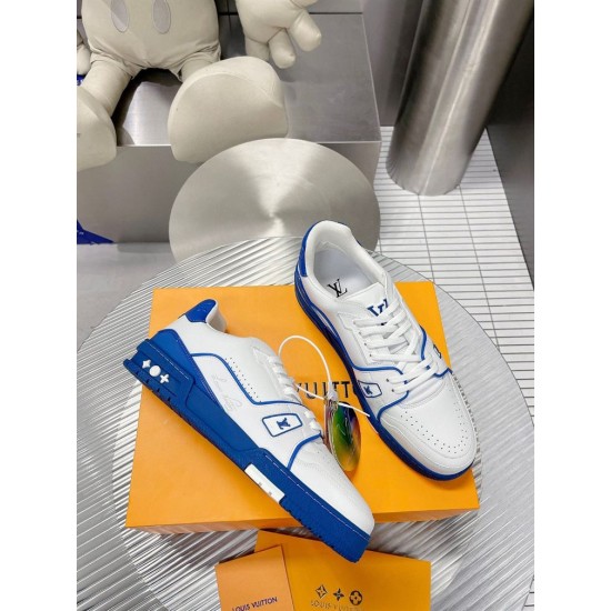 Pair of L Trainer Low Top Leather White And Blue Sneakers arranged on orange packaging