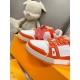 Macro detail shot of the toe box and side panels on L Trainer Low Top Orange And White Leather Sneakers