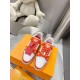 Top-down view of L Trainer Low Top Orange And White Leather Sneakers displaying laces and tongue