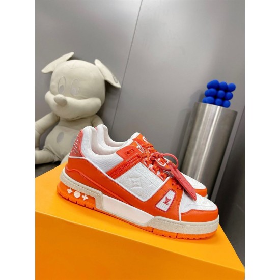 Angled perspective view showing L Trainer Low Top Orange And White Leather Sneakers with orange tag