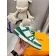 L Trainer Sneaker In Green And White Monogram Leather Outer Side View Handheld view showcasing the outer side panel of the green and white L Trainer Sneaker