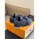 L Monogram Denim Low Top Trainer Sneakers Rear Angle in denim and black Rear angle view of L Monogram Denim Low Top Trainer Sneakers displaying heel in denim and black