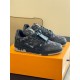 L Monogram Denim Low Top Trainer Sneakers Angle View in denim and black Angle view of L Monogram Denim Low Top Trainer Sneakers resting on orange box in denim and black