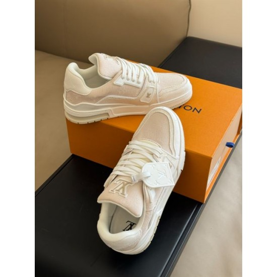 L Beige Trainers Front Upper View in beige and white Front upper view of L beige trainers showcasing lacing and padded collar in beige and white