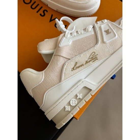L Beige Trainer Side Lettering Detail in beige and white Side close-up of L beige trainer showing cursive lettering and white overlays