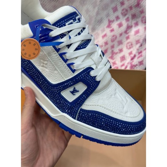 Detailed close-up on the blue rhinestone encrusted quarter panel of L Trainer Rhinestone Blue White Leather Low Top Sneakers