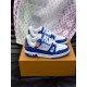 Pair of L Trainer Rhinestone Blue White Leather Low Top Sneakers resting on a branded orange box