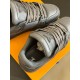 Close-up of the tongue emblem and lacing system on the grey L trainers in monochrome and grey