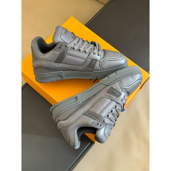 Angled layout showing the side branding and upper construction of the grey L trainers in monochrome and grey