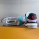 Bottom sole and rear heel view of the L Trainer Sneaker in light blue and purple