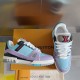 Pair of L Trainer Sneakers in light blue and purple arranged with packaging