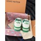 L Trainer Sneakers Heel Detail in white and green Rear view showing white heel tabs with green branding on L trainers