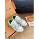 L Trainer Sneakers Top Angle View in white and green Top angled view of pair of L white and green sneakers