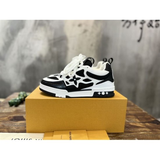 L Skater Style Chunky Black And White Trainers On Box Side profile of L skater style chunky black and white trainers resting on a branded box