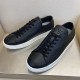 L Resort Black Grained Leather Trainers Angled Pair in black and white Angled pair view of black grained leather trainers highlighting tongue hardware in black and white