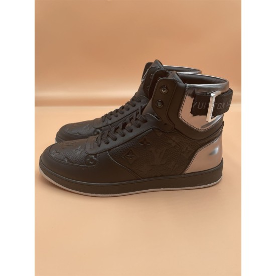 L Rivoli High-Top Leather Monogram Trainers In Black - Inner Angle Angled view focusing on the inner side of the black L high-top trainers
