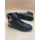 L Rivoli High-Top Leather Monogram Trainers In Black - Sole View Front view of black L high-top trainers with one trainer showing its patterned sole