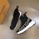L Run Knit Sock Sneaker Boot Top Angle in black and white Top-down view of a pair of black L Run Knit Sock Sneaker Boots with bold white lettering.