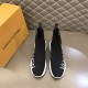 L Run Knit Sock Sneaker Boot Front View in black and white Front view of both black L Run Knit Sock Sneaker Boots showing toe boxes and high collar fit in black and white