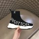 L Run Knit Sock Sneaker Boot In Hand in black and white Hand holding the L Run Knit Sock Sneaker Boot in black to display the side profile and flexibility in black and white
