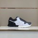 Lateral View of L Trainers in grey and white Lateral view of L grey and white low top trainers on display