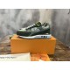 L green trainers displayed next to orange presentation box and documentation