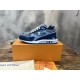 L blue mesh suede low top trainers angled on orange box L blue mesh suede low top trainers angled on orange box