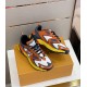 L Runner Tatic Trainers Pair on Box in orange and yellow Pair of L Runner Tatic orange mesh and suede trainers resting on a branded orange box in orange and yellow