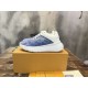 L Blue and White Trainers on Box Side profile of L blue and white trainers displayed on a branded box