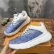 L Blue and White Trainers Pair Angle Angled view of a pair of L blue and white trainers showcasing lace-up design