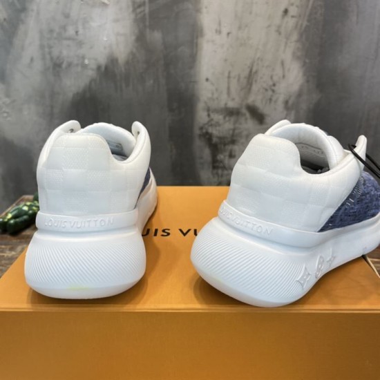 L Blue and White Trainers Heel View Rear view of L blue and white trainers showing white heel panels and debossed branding