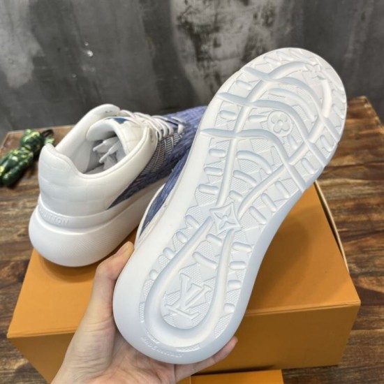 L Blue and White Trainers Sole View Underside view of the white treaded outsole on L blue and white trainers