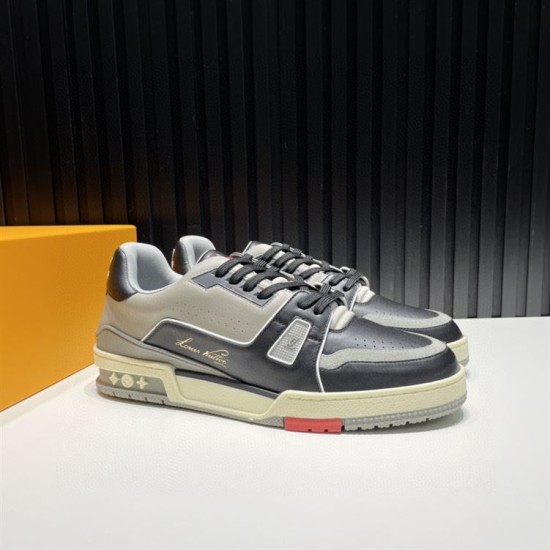 L Trainer Pair Three-Quarter View in black and grey L Trainer low top black and grey leather trainers pair shown from three-quarter angle