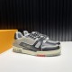 L Trainer Pair Three-Quarter View in black and grey L Trainer low top black and grey leather trainers pair shown from three-quarter angle