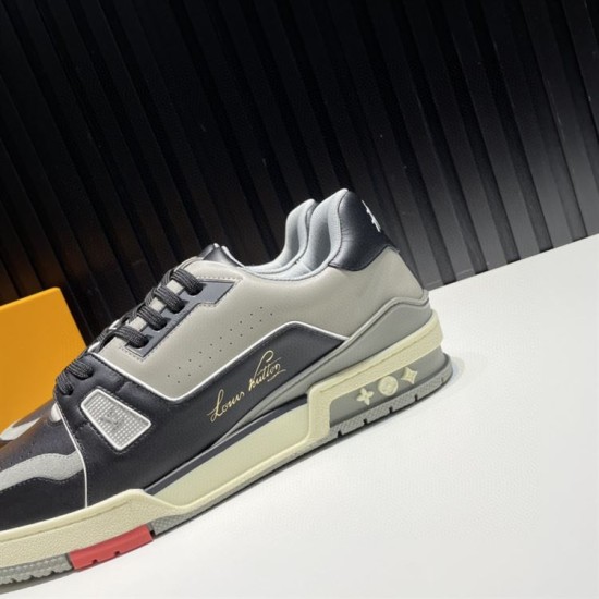 L Trainer Side Panel Detail in black and grey L Trainer low top black and grey leather trainer close-up on side panel and gold signature branding
