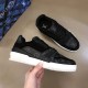 Overhead Angle - L Trainer Monogram Canvas Low Top Black Trainers in black and white Top-down angled view of L Trainer Monogram Canvas Low Top Black Trainers held in hand in black and white
