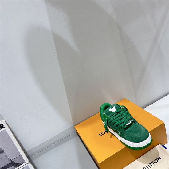 Green L Suede Platform Sneakers Top Angle in green and white Angled top-down view of green L suede platform sneakers resting on an orange box in green and white