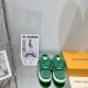Green L Suede Platform Sneakers Front View in green and white Front view of green L suede platform sneakers showing thick laces and toe box details in green and white