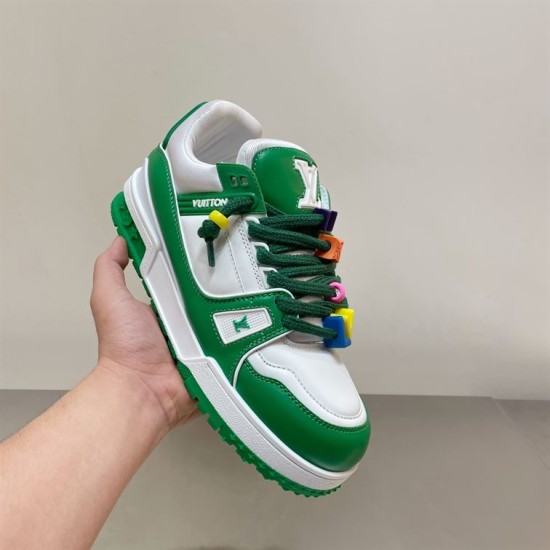 L Trainer Maxi Low Top Trainers White Green - Dynamic Hold Handheld dynamic angle of L Trainer Maxi trainers showing white and green panels