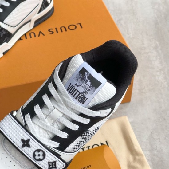 Tongue detail of L Monogram Denim Strap Trainers in denim and black Close up of the tongue branding on L Monogram Denim Strap Trainers in denim and black
