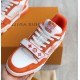 Front Angled View of Orange L Trainer Monogram Denim Low Top Trainers in orange and white Angled view focusing on laces and branded tongue of orange and white L trainers