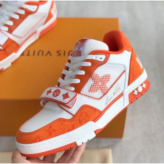 Three Quarter View of Orange L Trainer Monogram Denim Low Top Trainers in orange and white Three quarter angle of orange and white L trainers displaying side script logo